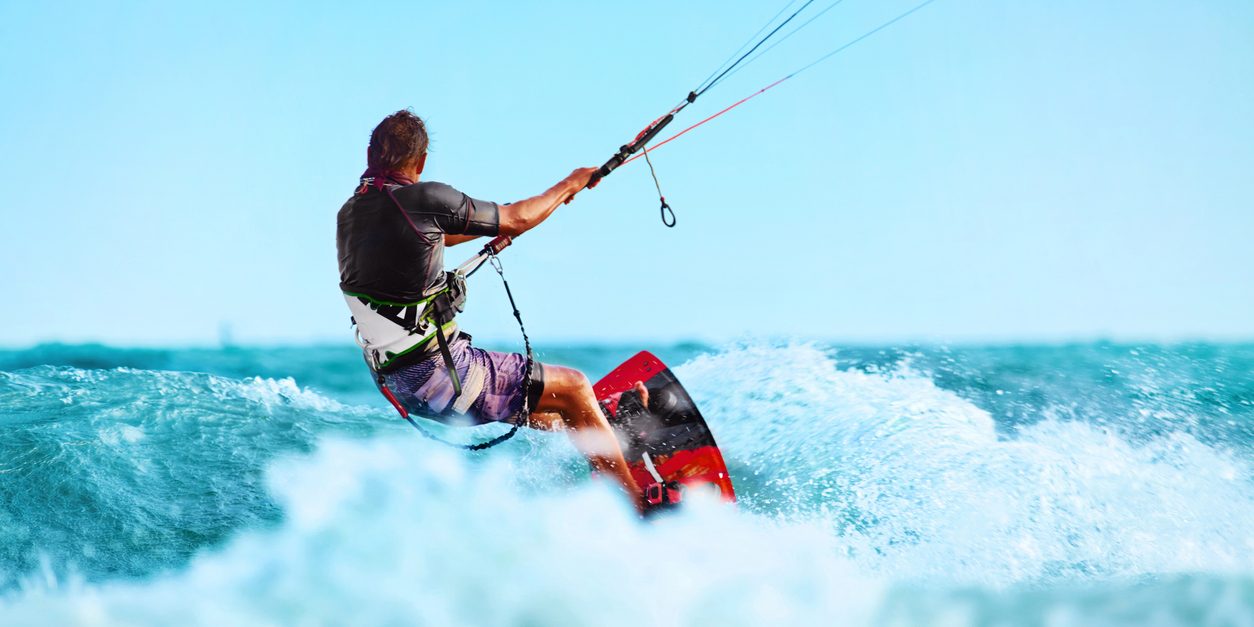 Kiteboarding, Kitesurfing. Water Sports. Professional Kite Surfer In Action On Waves In Ocean. Extreme Sport. Healthy Active Lifestyle. Hobby. Recreational Sporting Activity. Summer Fun, Adventure